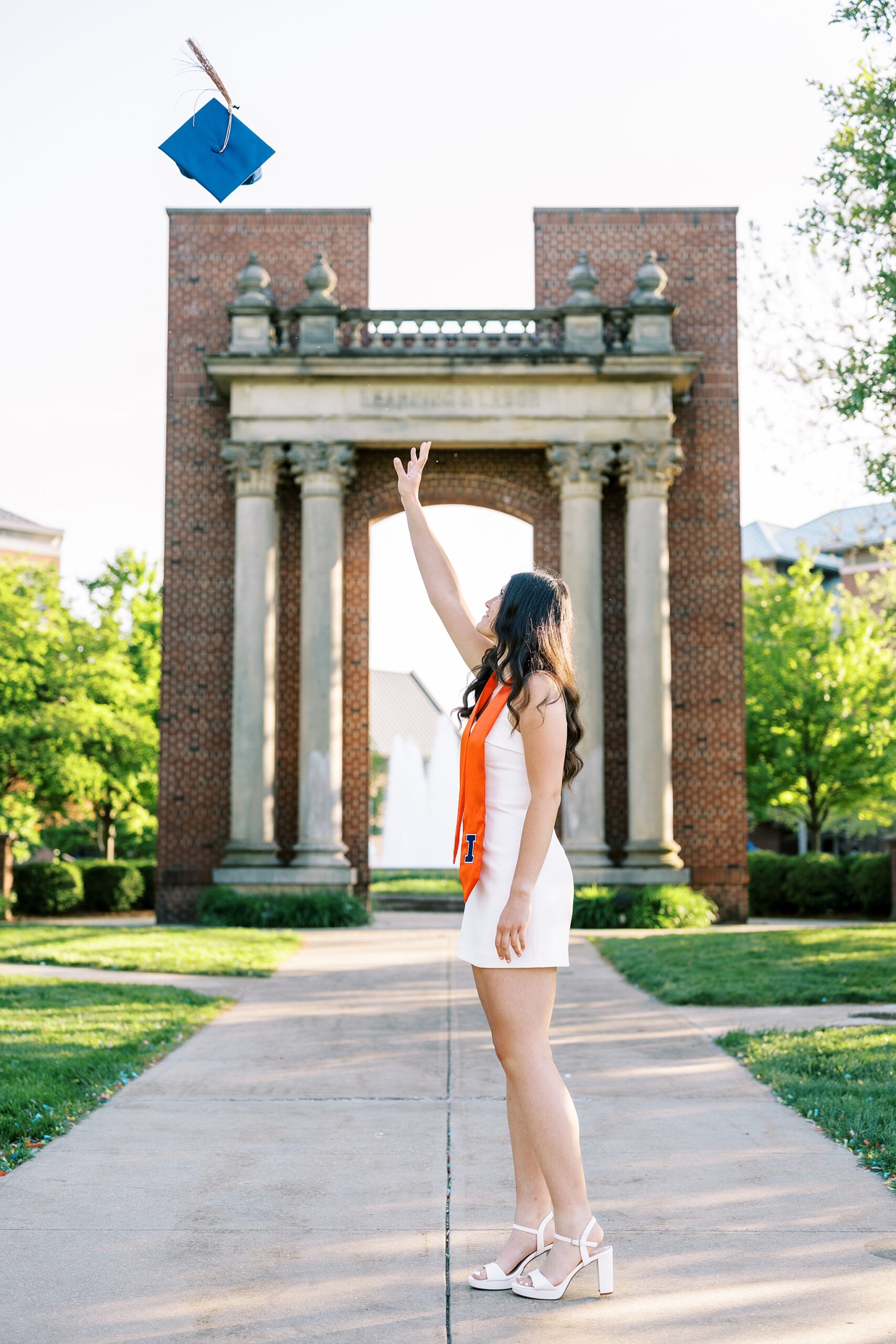 Graduation portraits at the University of Illinois in Champaign-Urbana featuring cap and gown photos at iconic UIUC locations by Kim Ritchie Photography.