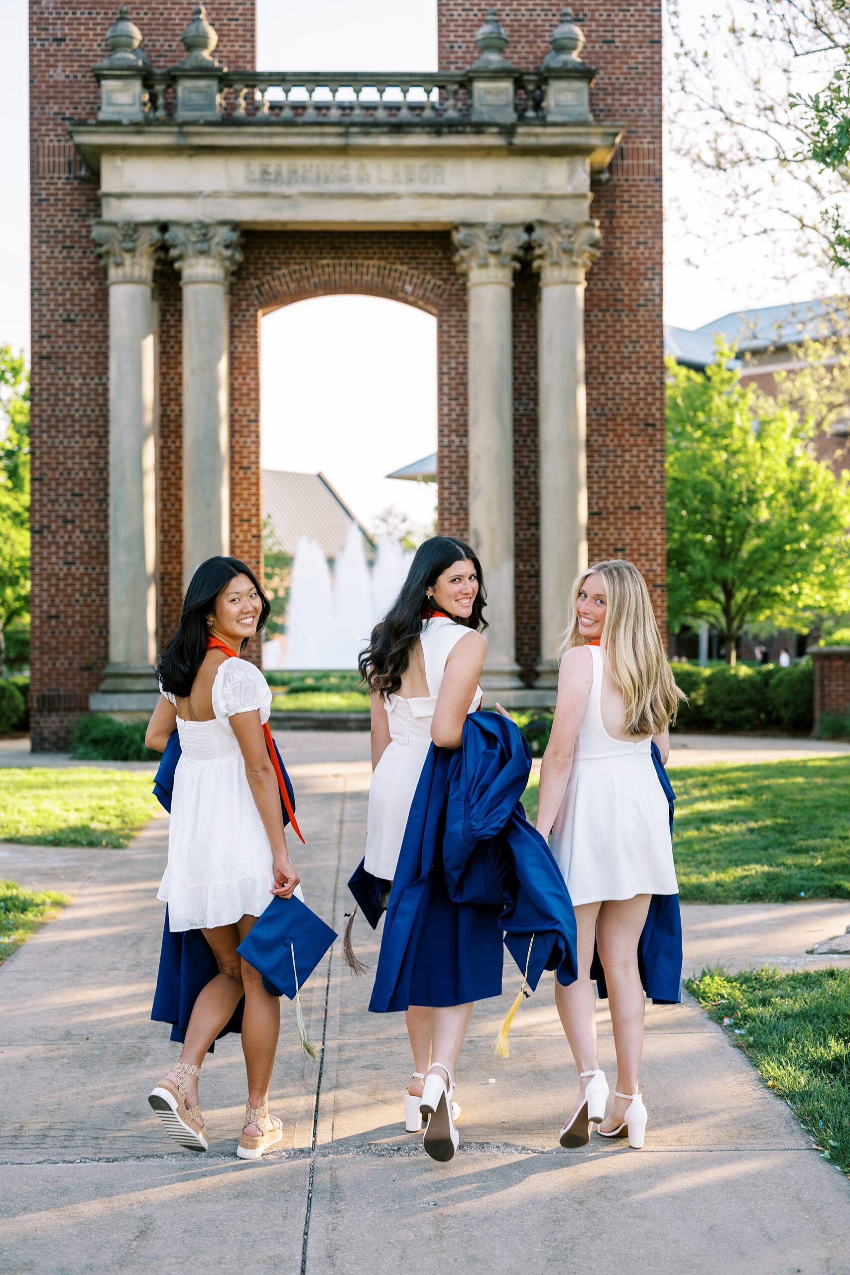 Graduation portraits at the University of Illinois in Champaign-Urbana featuring cap and gown photos at iconic UIUC locations by Kim Ritchie Photography.