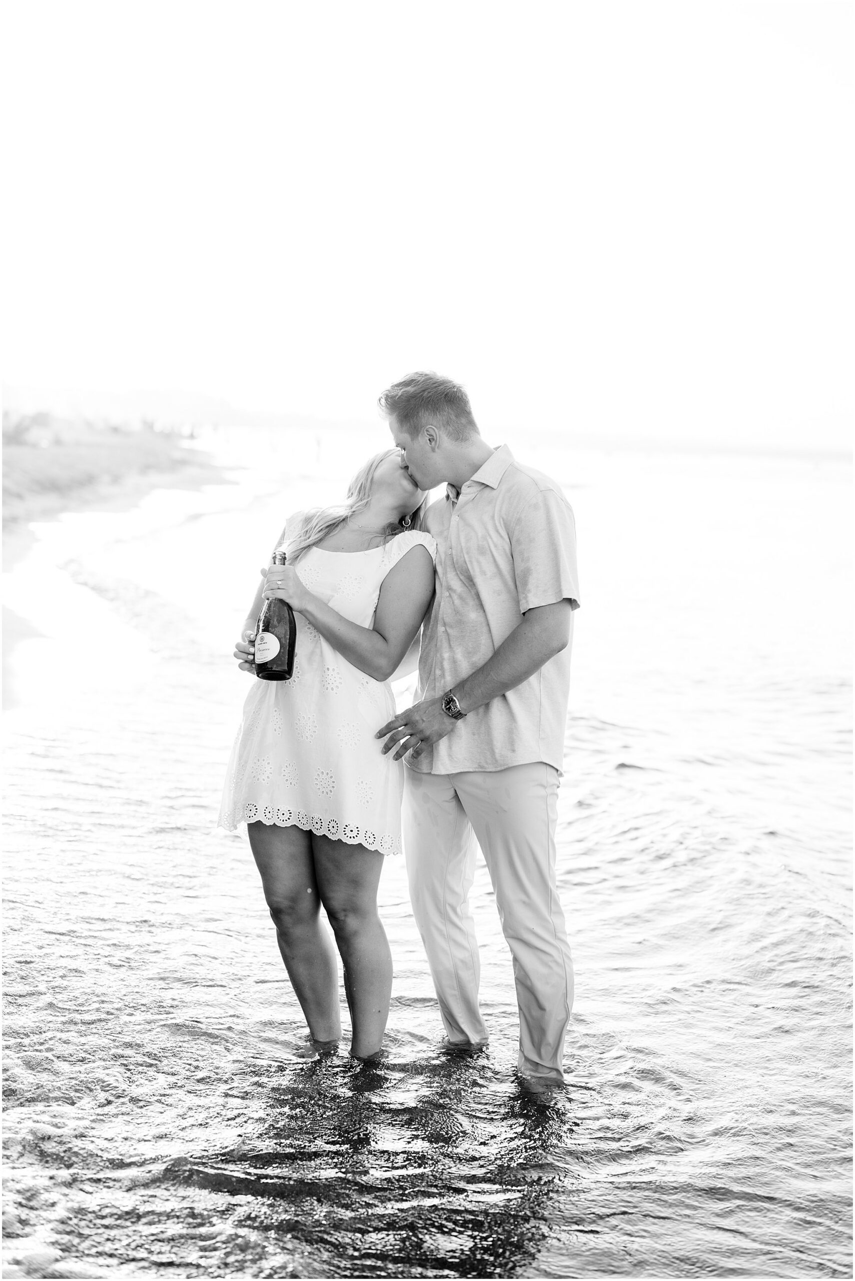 Emily & Jake’s summer engagement session at Gillson Beach in Wilmette featured beach photos, Lake Michigan views, golden hour, and a champagne pop.