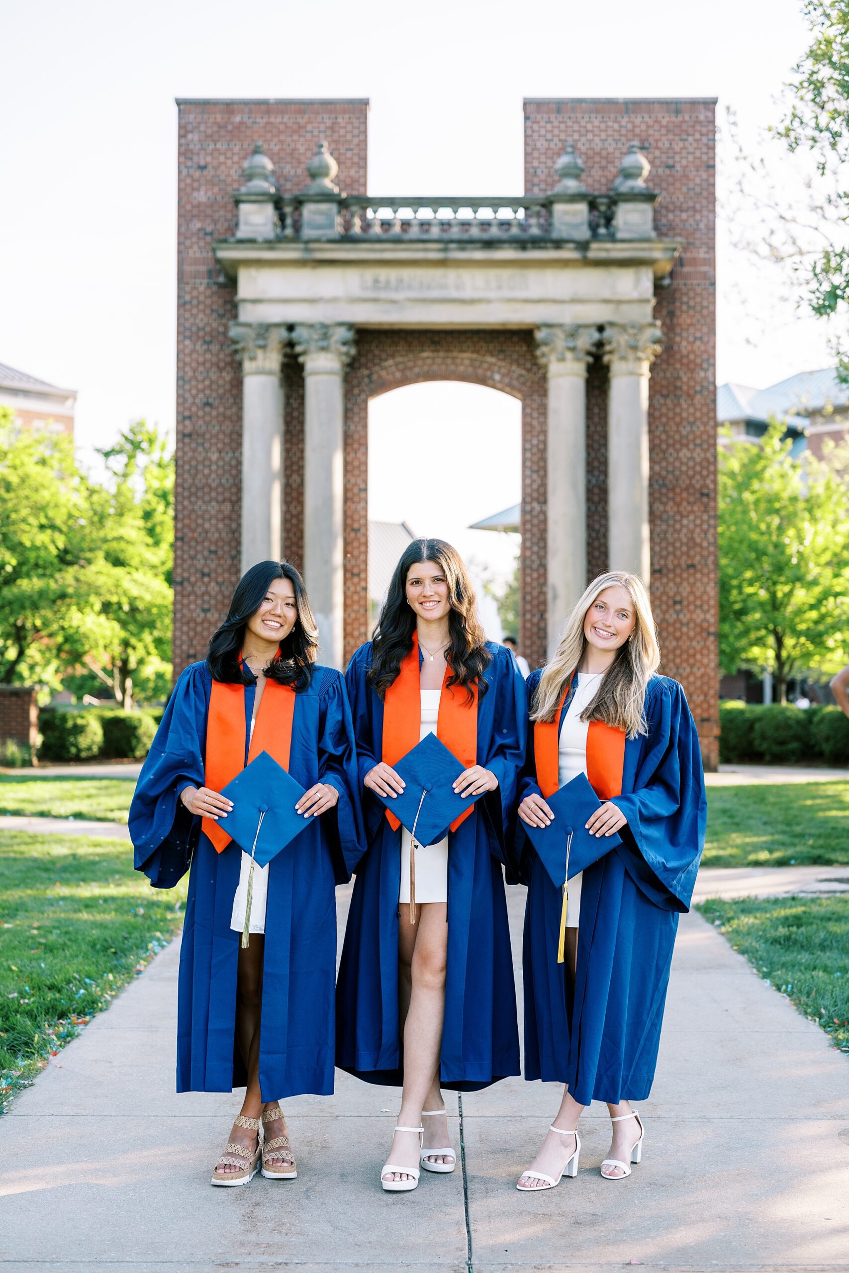 Graduation portraits at the University of Illinois in Champaign-Urbana featuring cap and gown photos at iconic UIUC locations by Kim Ritchie Photography.